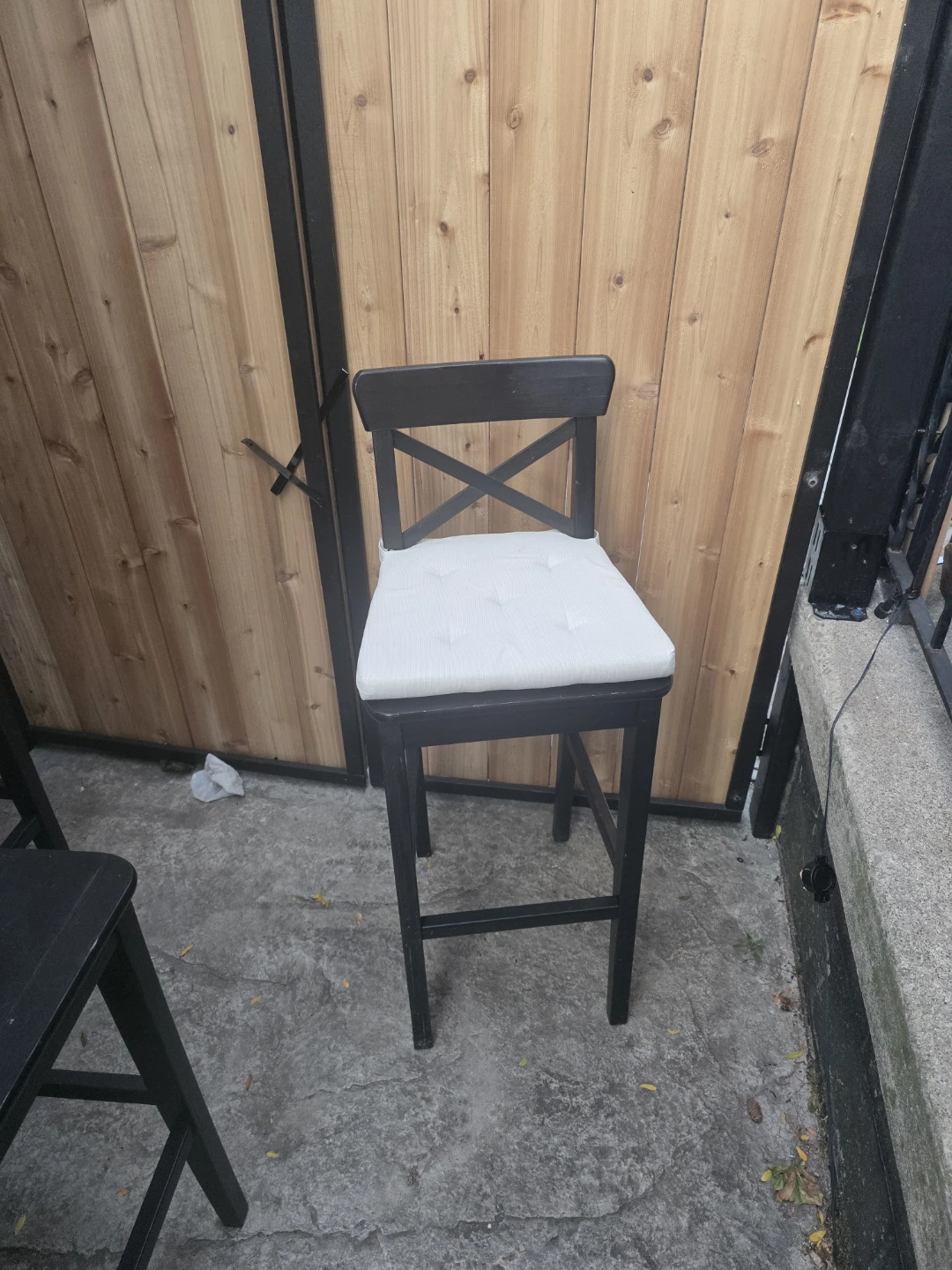 Set of 4 black bar stools with seat cushions