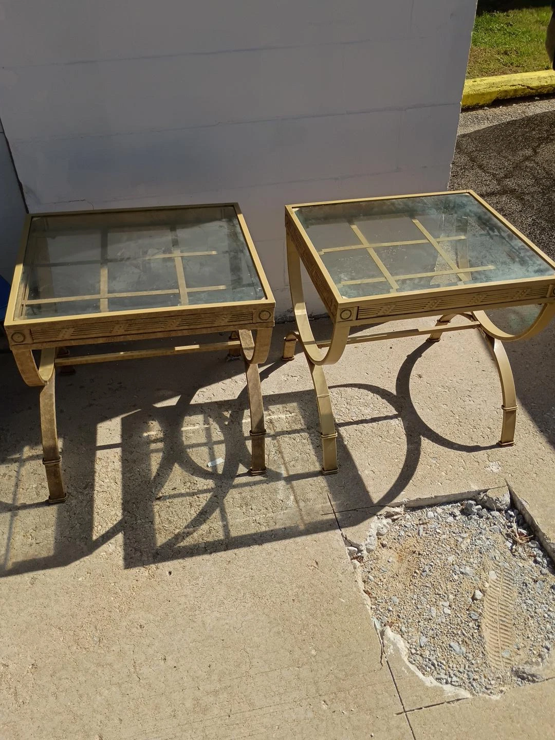 Set of two gold metal and glass side tables