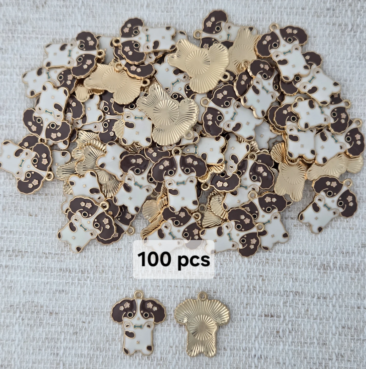 Set of 100 dog-shaped charms