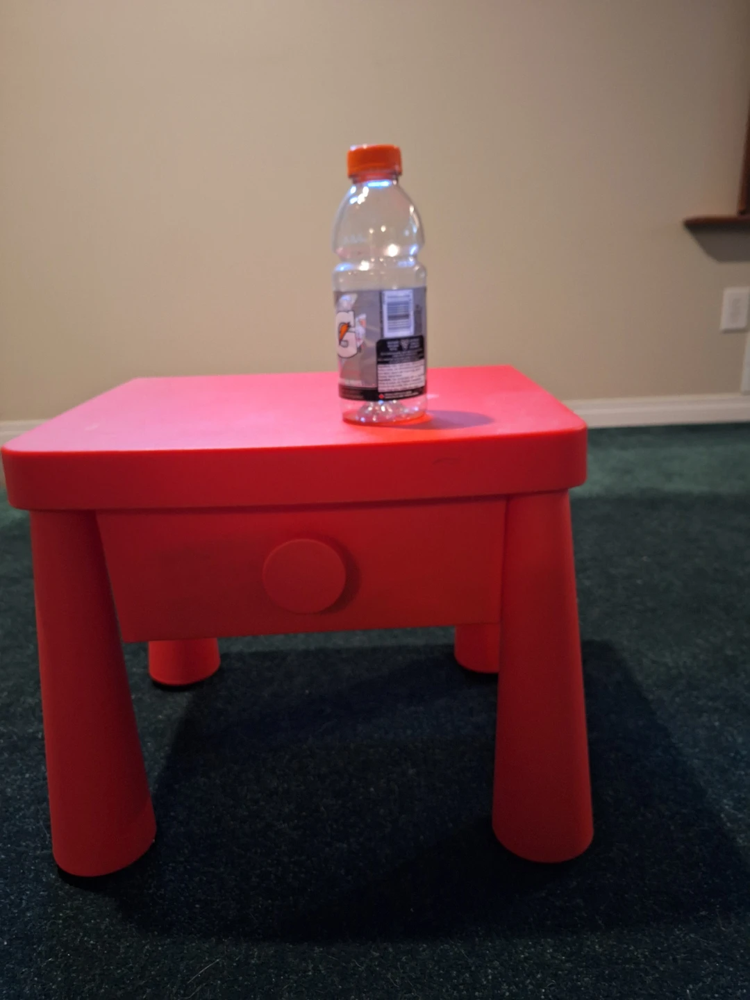 Red plastic kids table with storage drawer