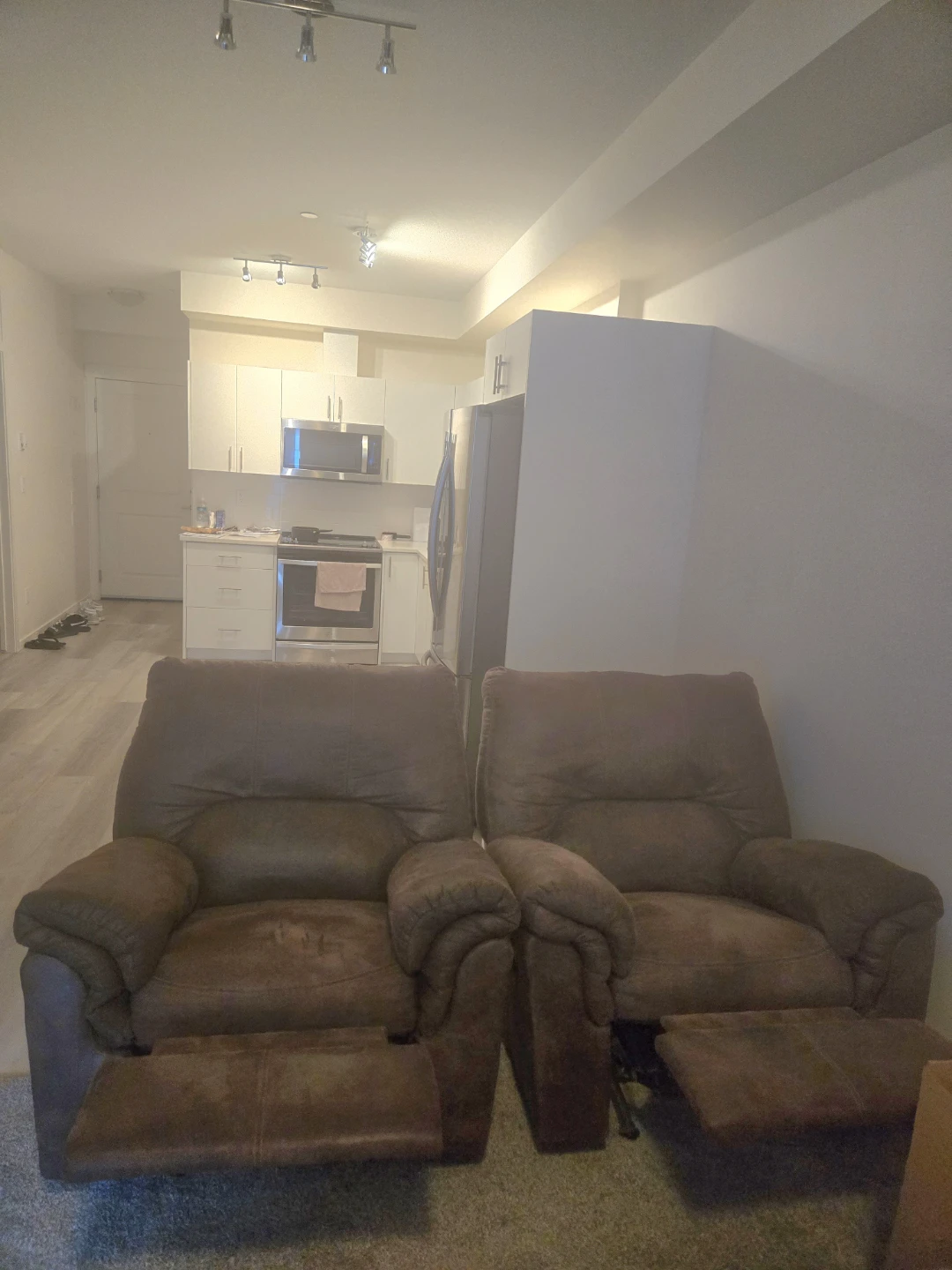 Two Brown Recliner Rocking Armchairs