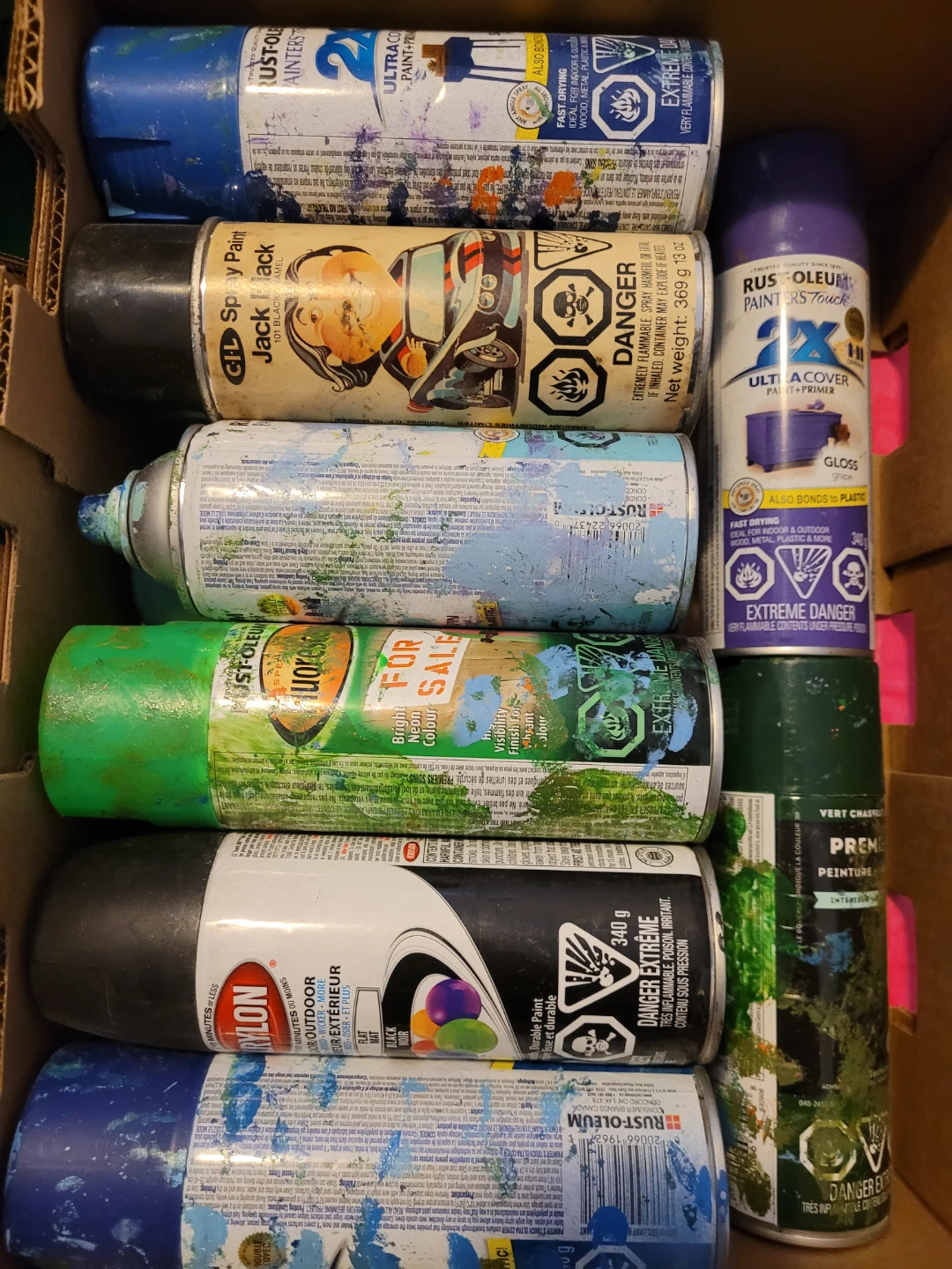 Assorted Spray Paint Collection and various colored papers