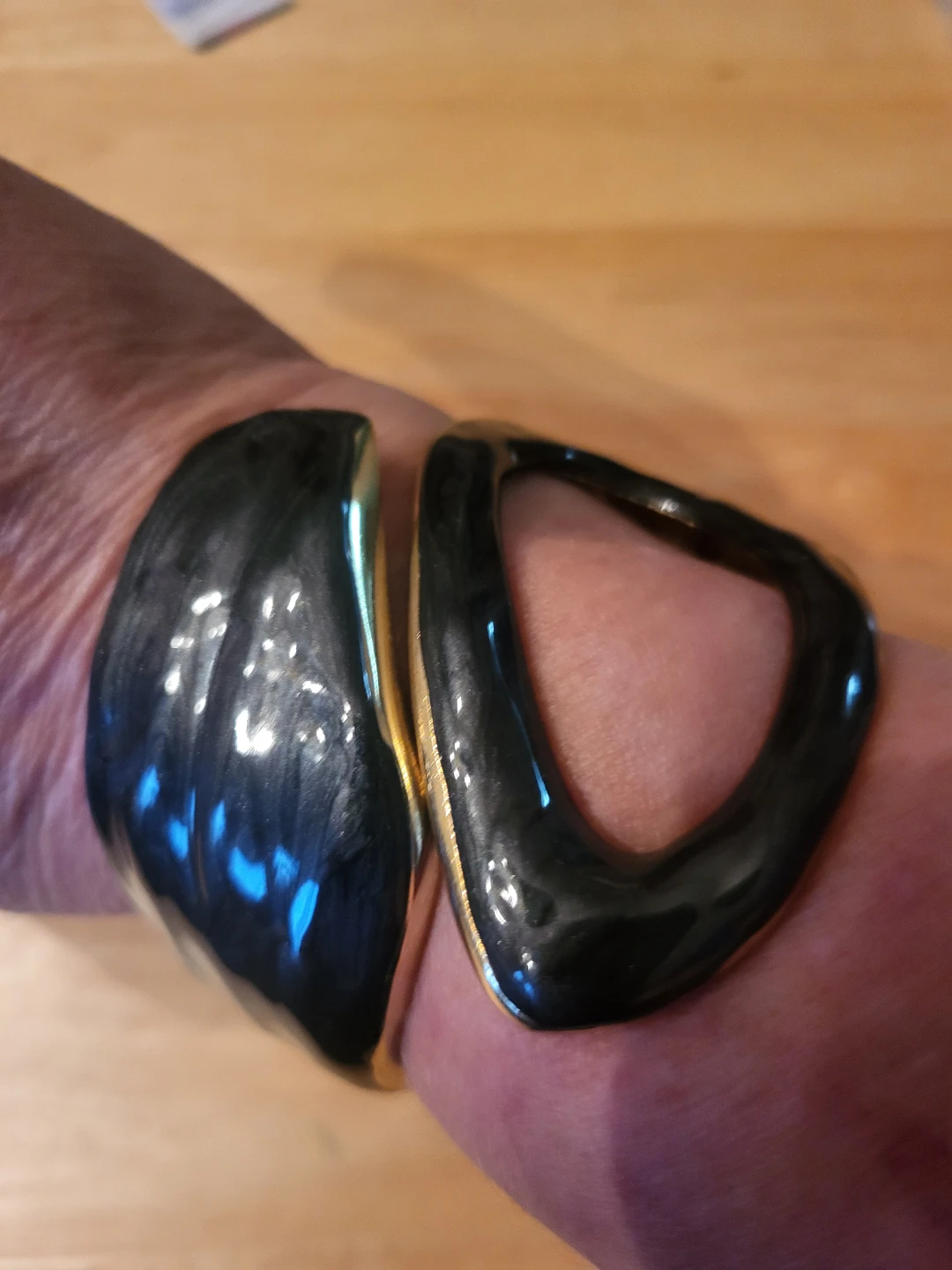 Black and gold tone hinged cuff bracelet