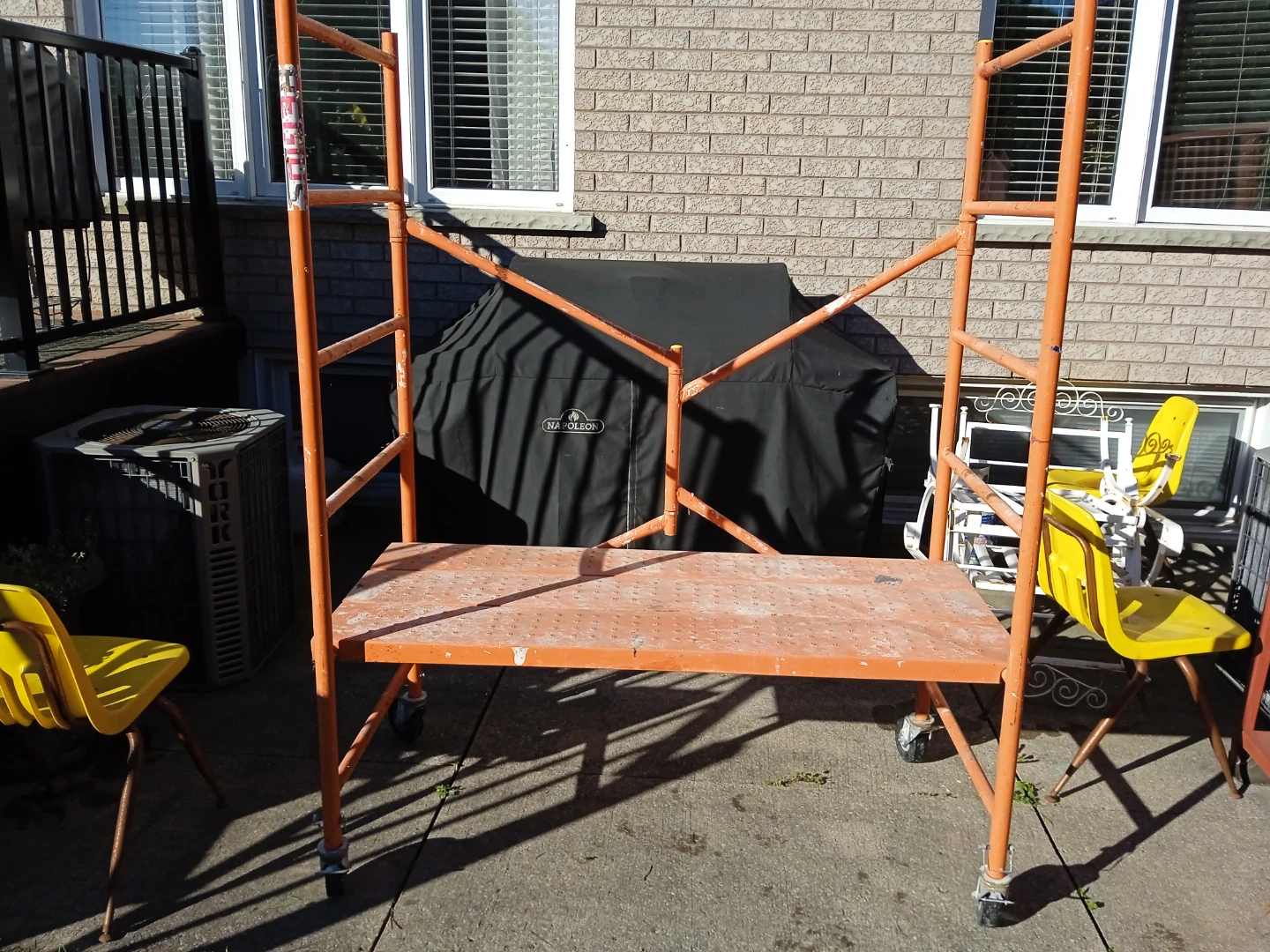 Orange metal rolling scaffold