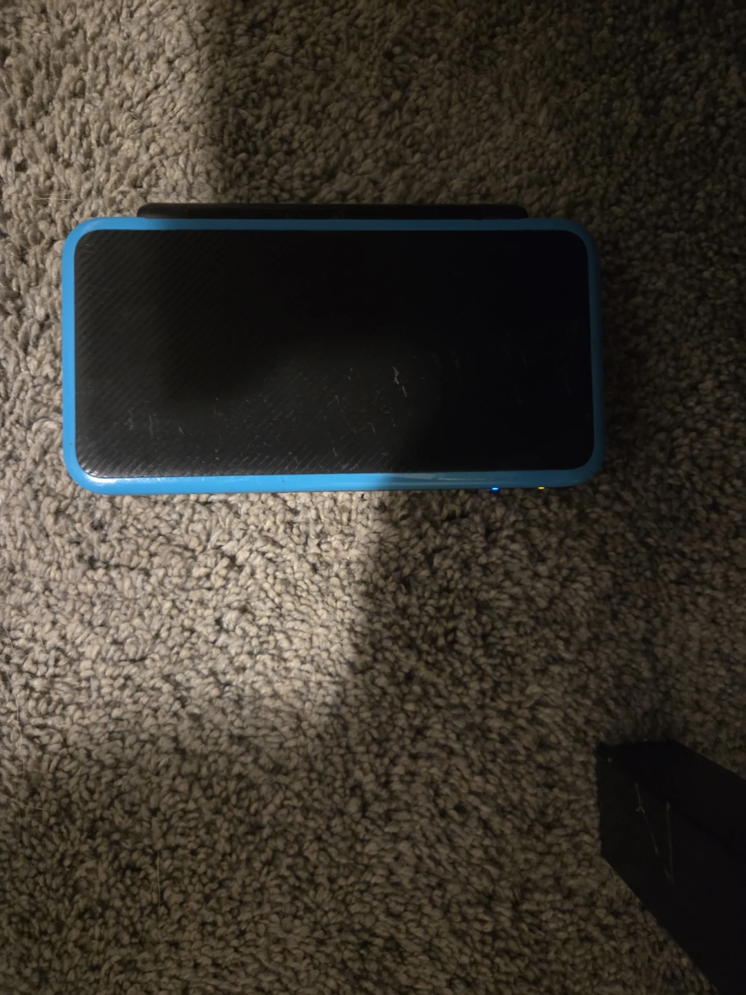 New Nintendo 2DS XL with a game and charger