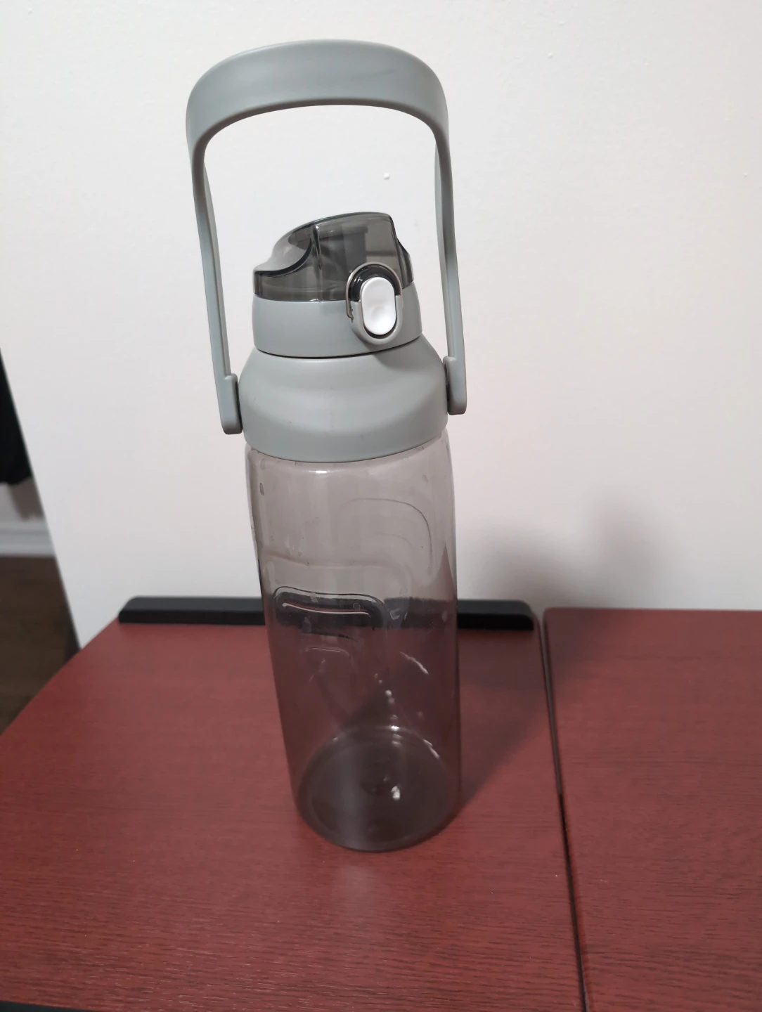 Grey plastic water bottle with carry handle