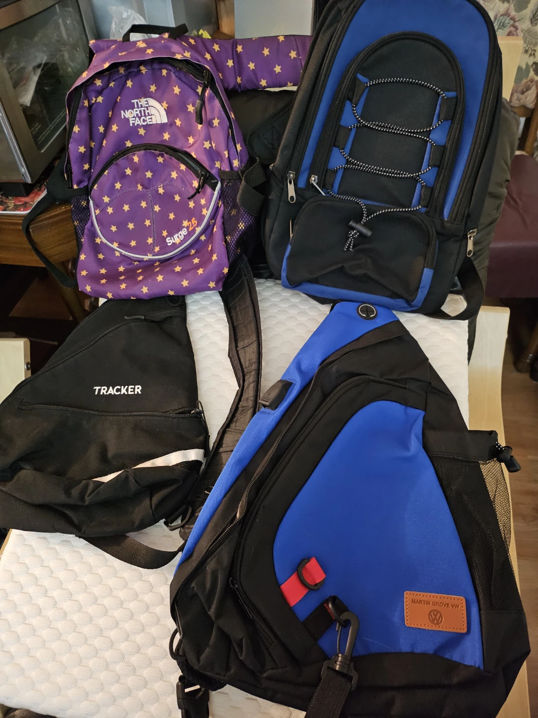 Assorted backpacks and sling bags