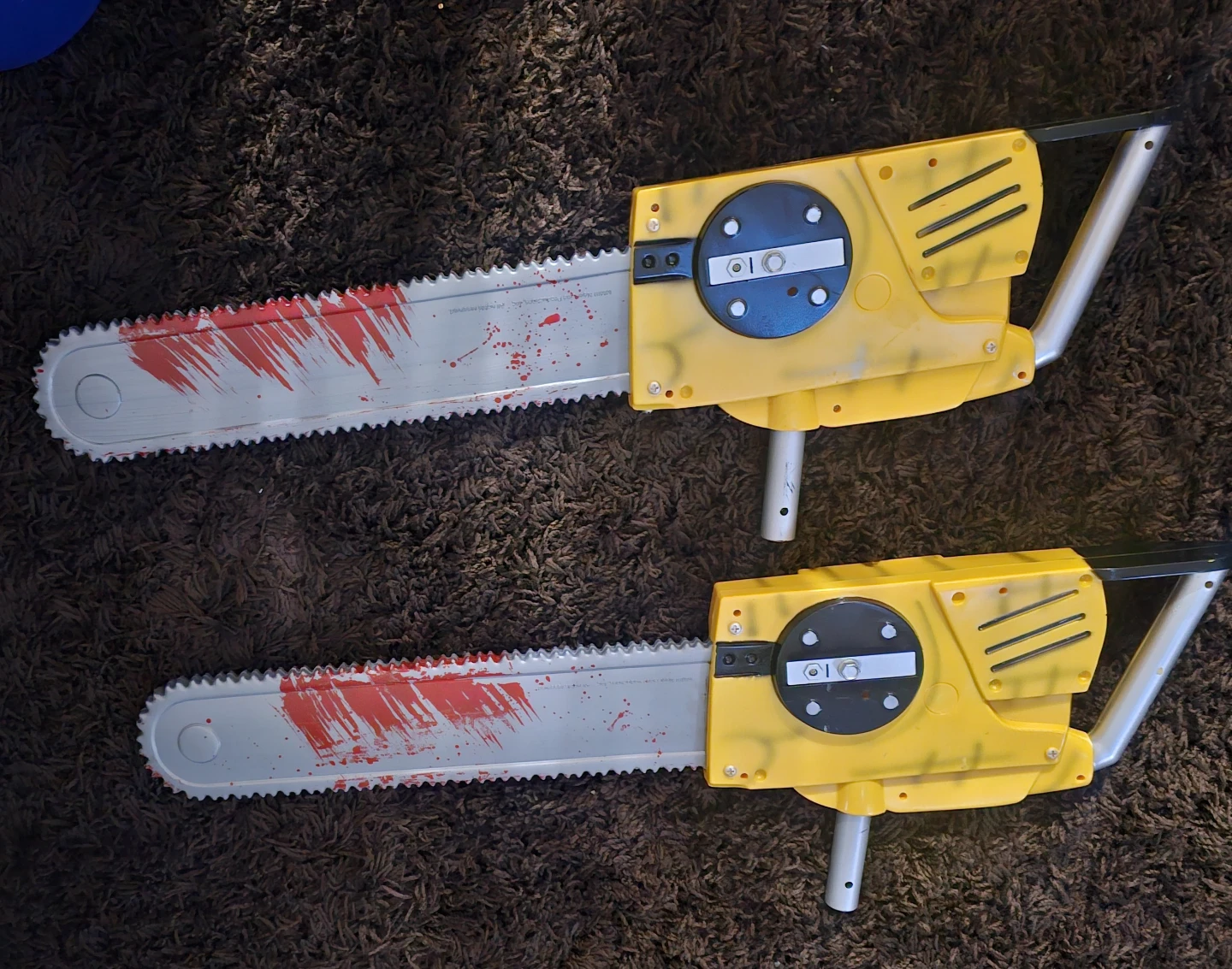 Two Toy Plastic Chainsaws