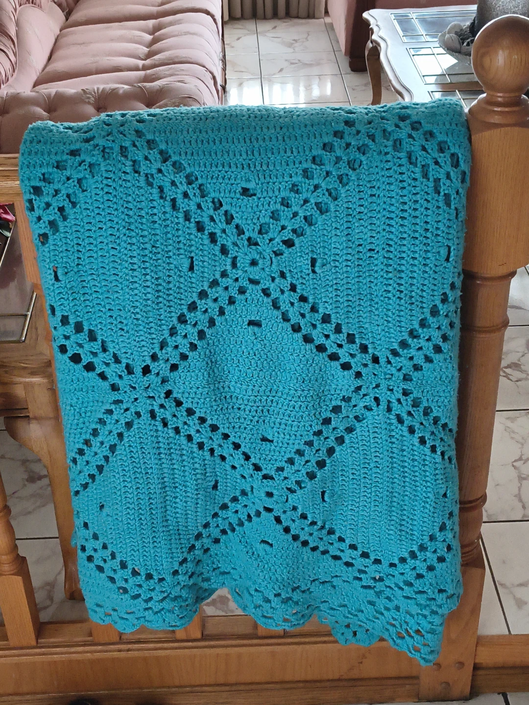 Hand-crocheted teal throw blanket