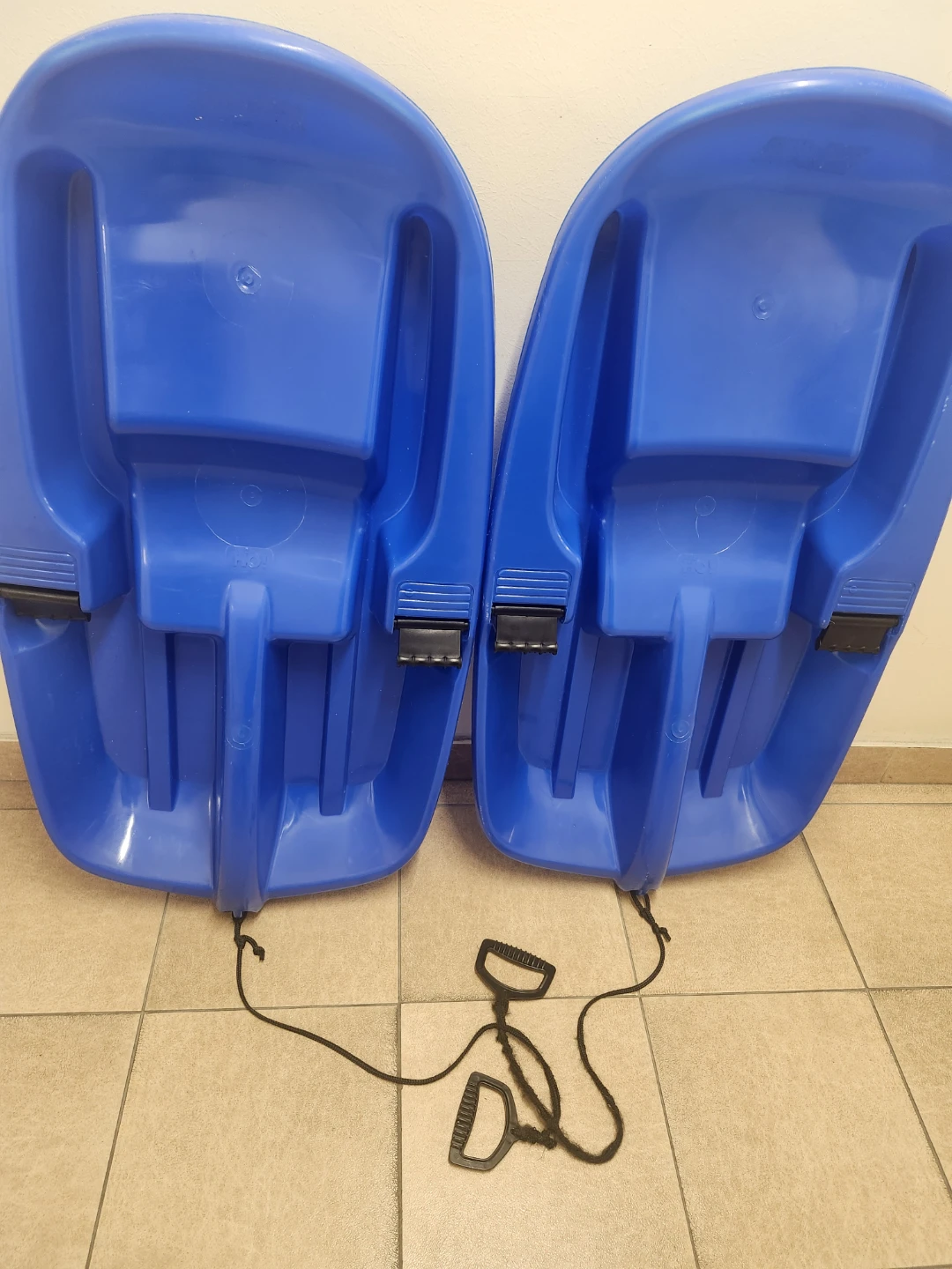 Two Blue Plastic Toboggan Sleds