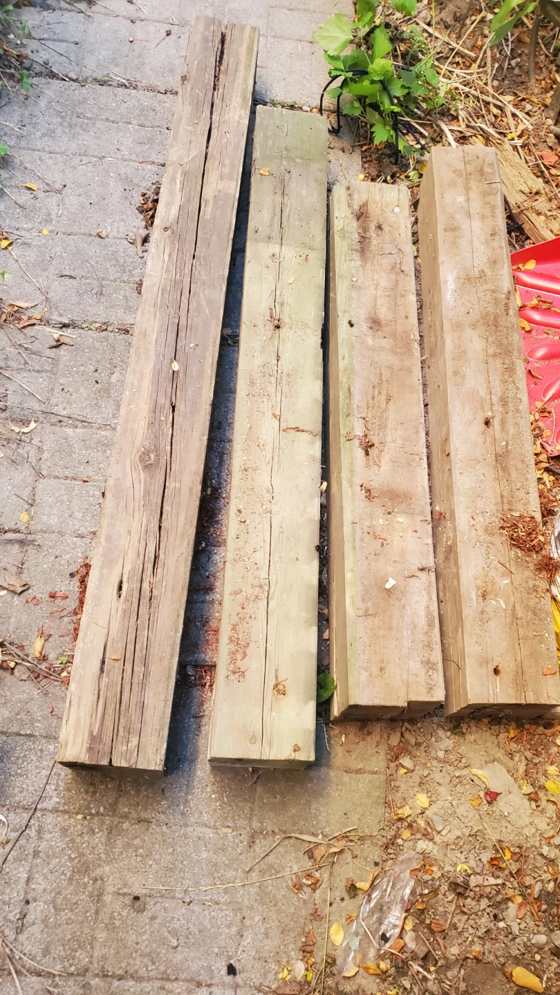 Set of four pressure-treated wooden posts