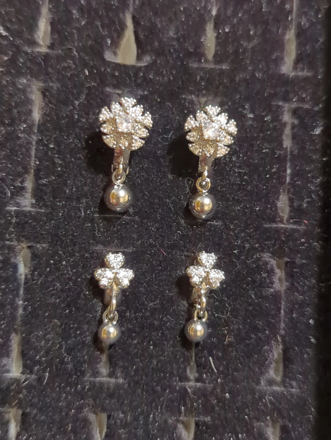Two pairs of silver tone dangle earrings