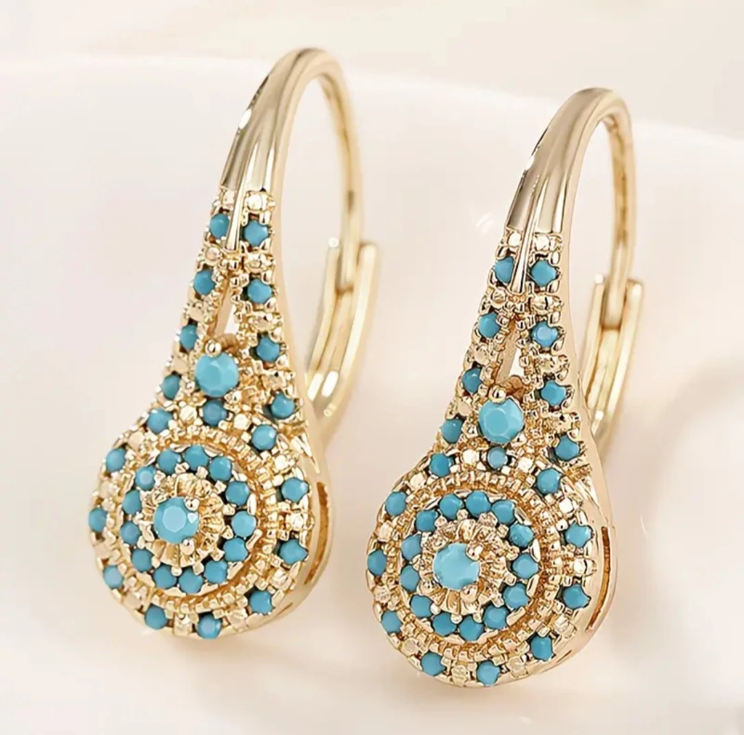 Gold-tone drop earrings with blue stone inlay