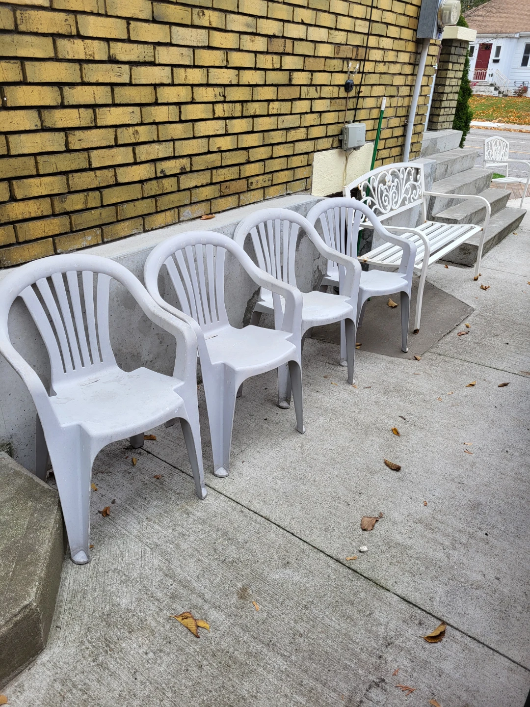 Set of 4 white plastic patio chairs