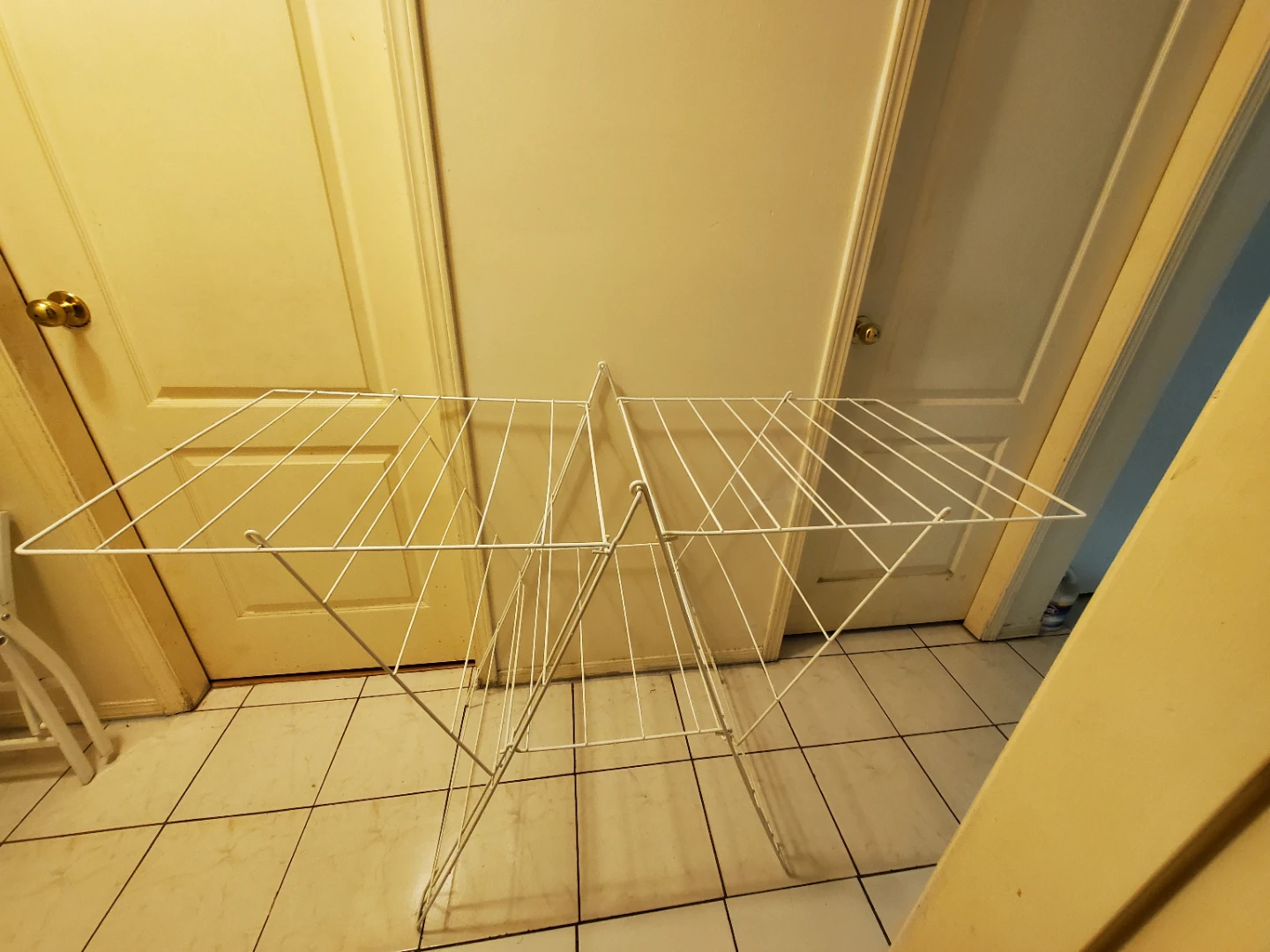 Collapsible white metal laundry drying rack