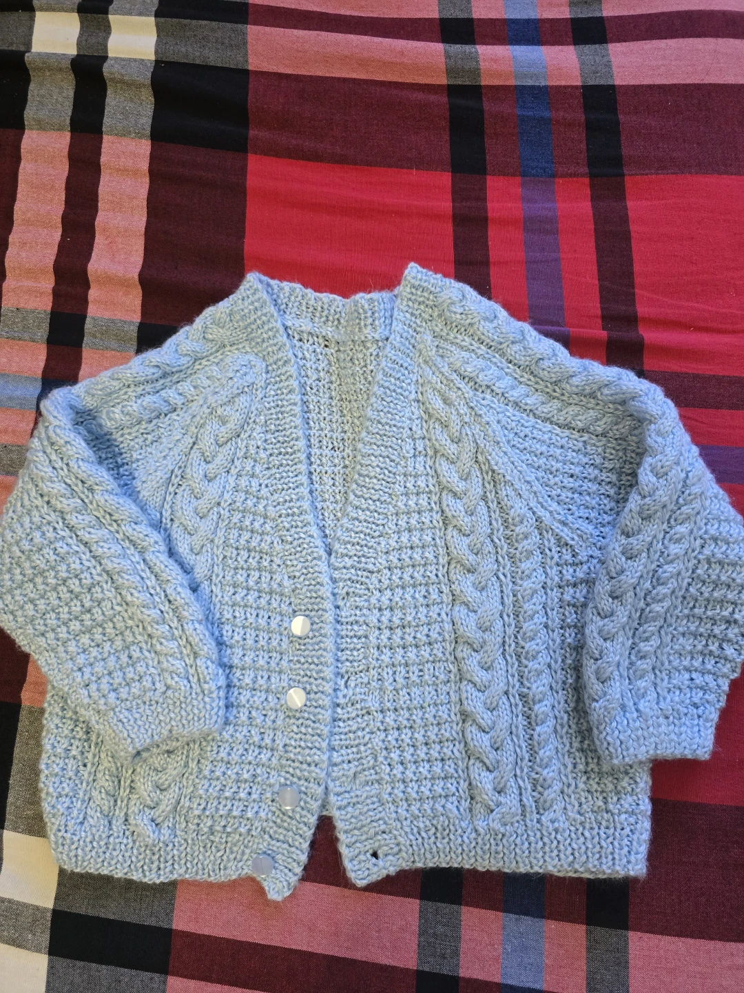 Hand-knitted baby cardigan in light blue