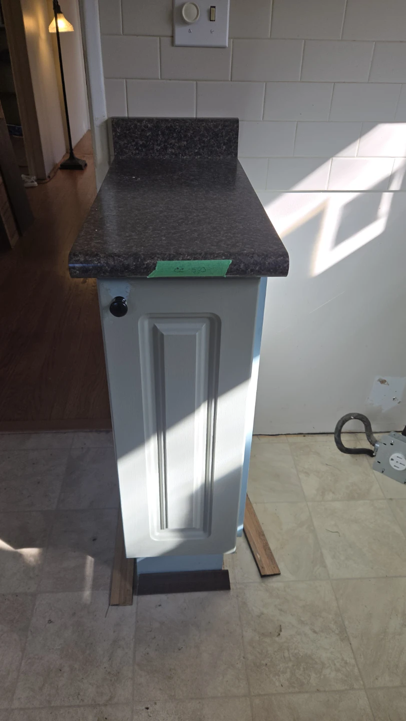 Narrow blue kitchen cabinet with countertop