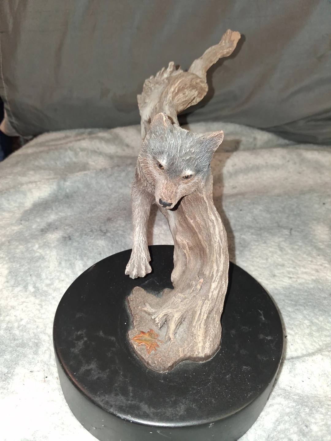Wolf figurine on driftwood base