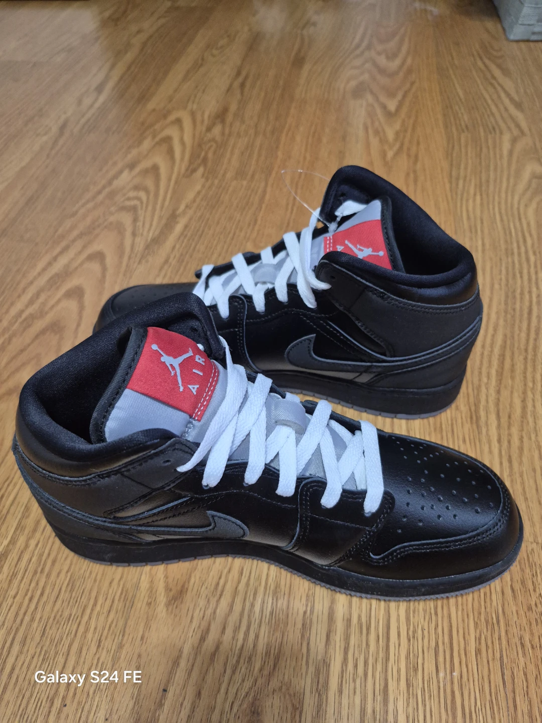 These are authentic Air Jordan 1 Mid sneakers in a black and red - photo 3
