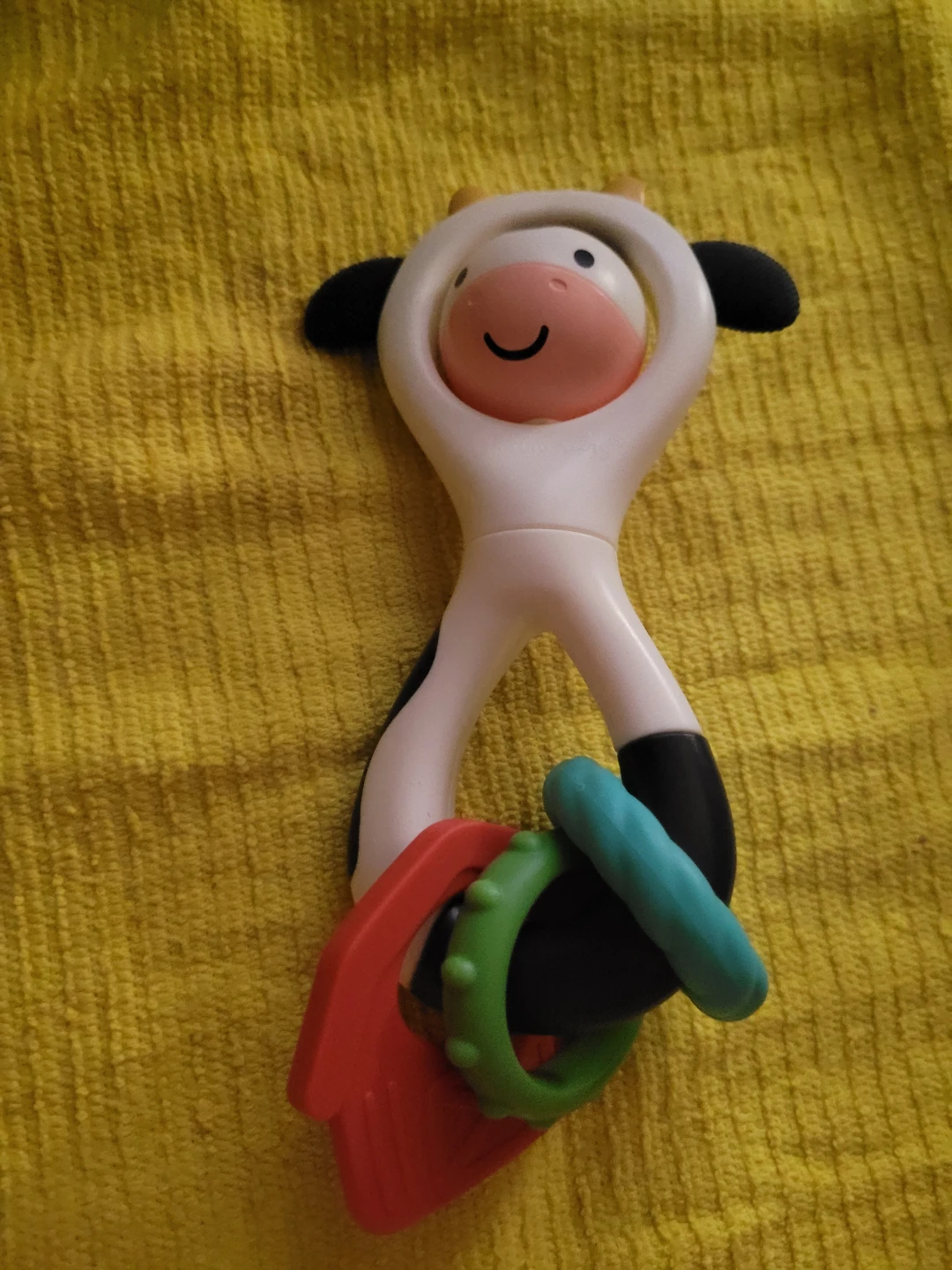 Itzy Ritzy Spinner Rattle - Cow, a 2-in-1 sensory toy
