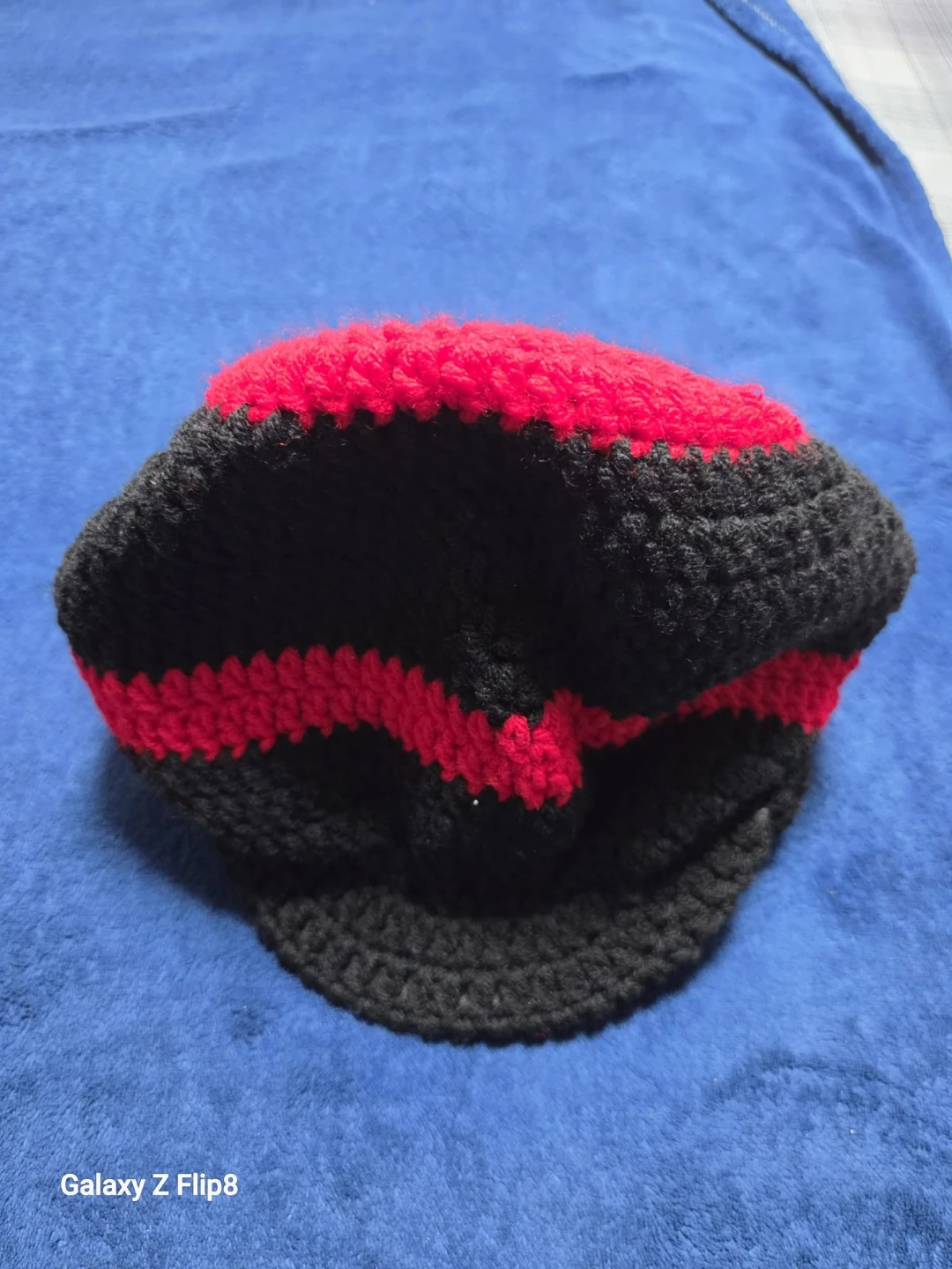 Hand-crocheted red and black striped newsboy cap