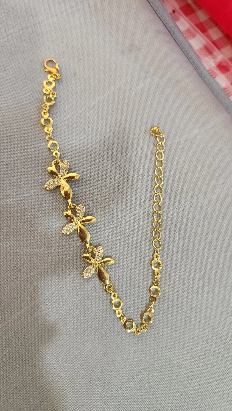 Gold-tone flower charm bracelet with rhinestones