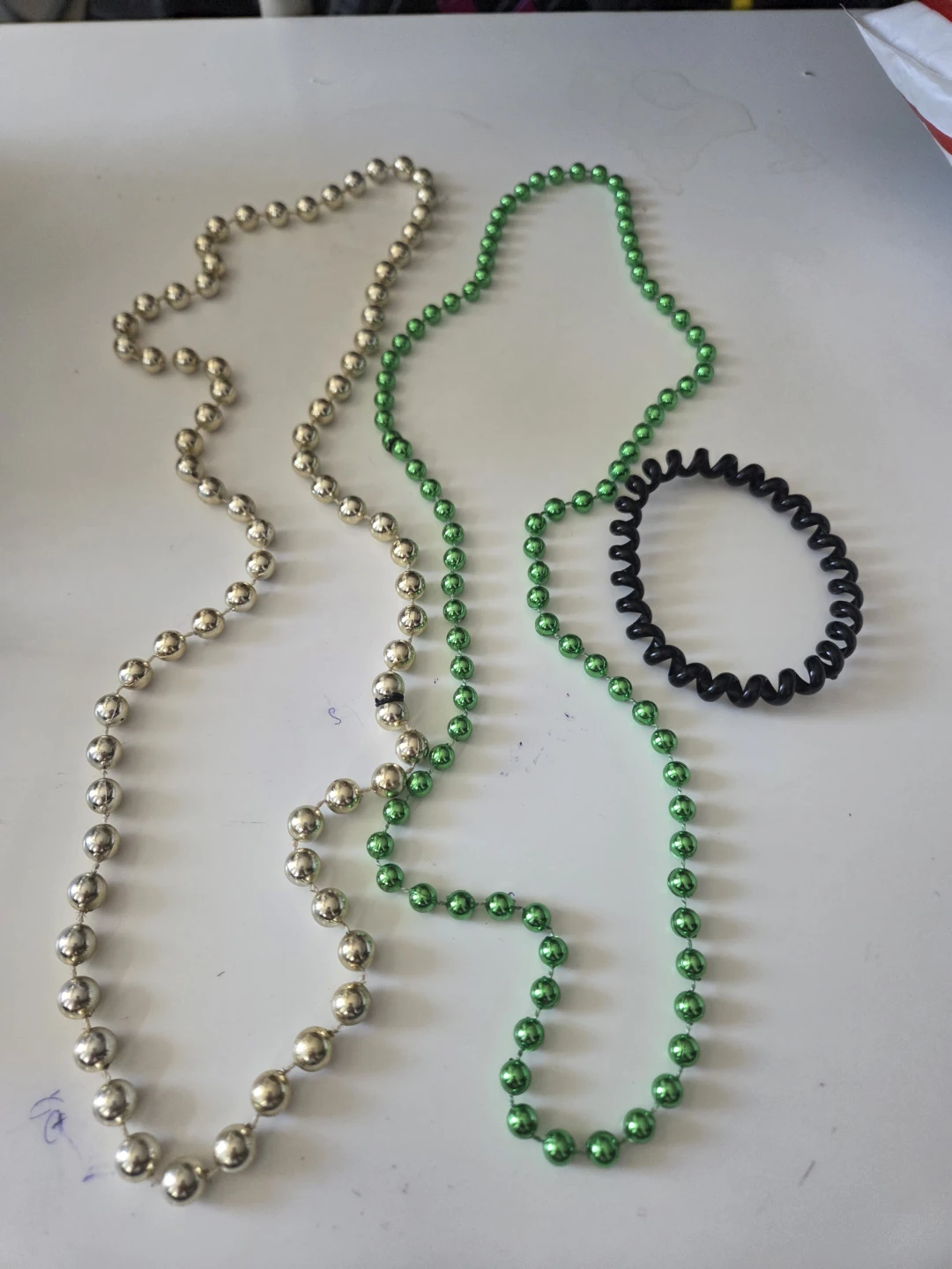 Two bead necklaces and one spiral hair tie