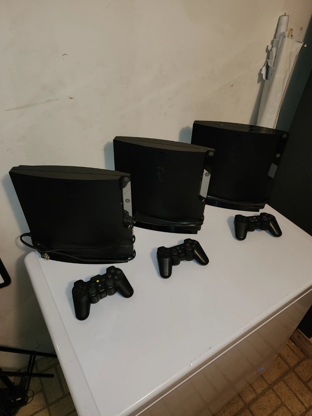Three Sony PlayStation 3 Super Slim Consoles with Controllers
