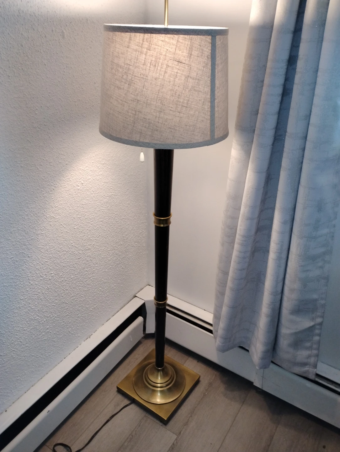 Floor lamp with brass base and fabric shade