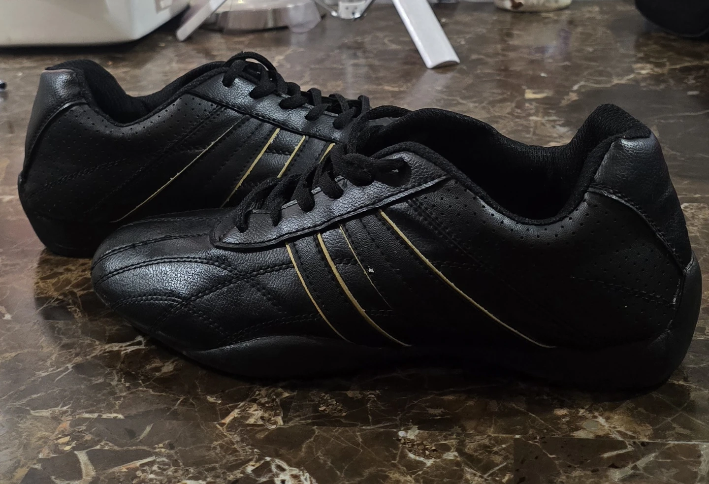 Black and gold athletic shoes
