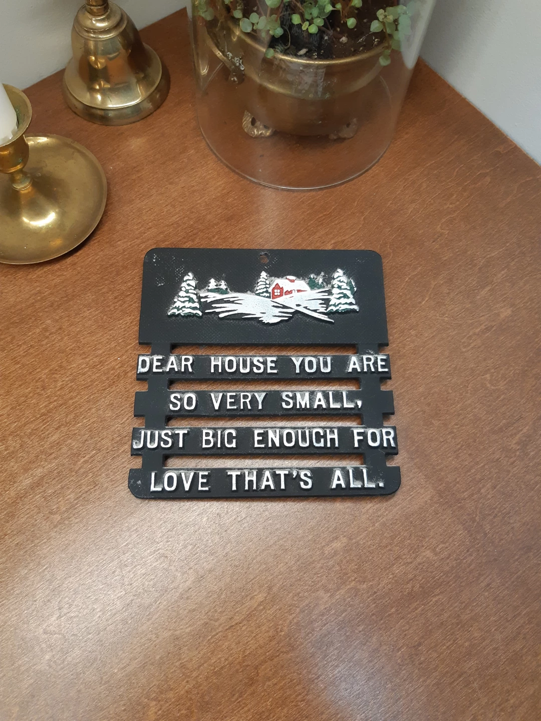 Vintage black metal log cabin trivet