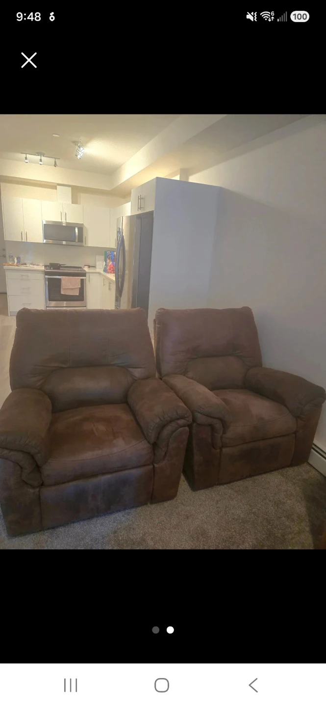 Two Brown Rocking Recliner Armchairs.