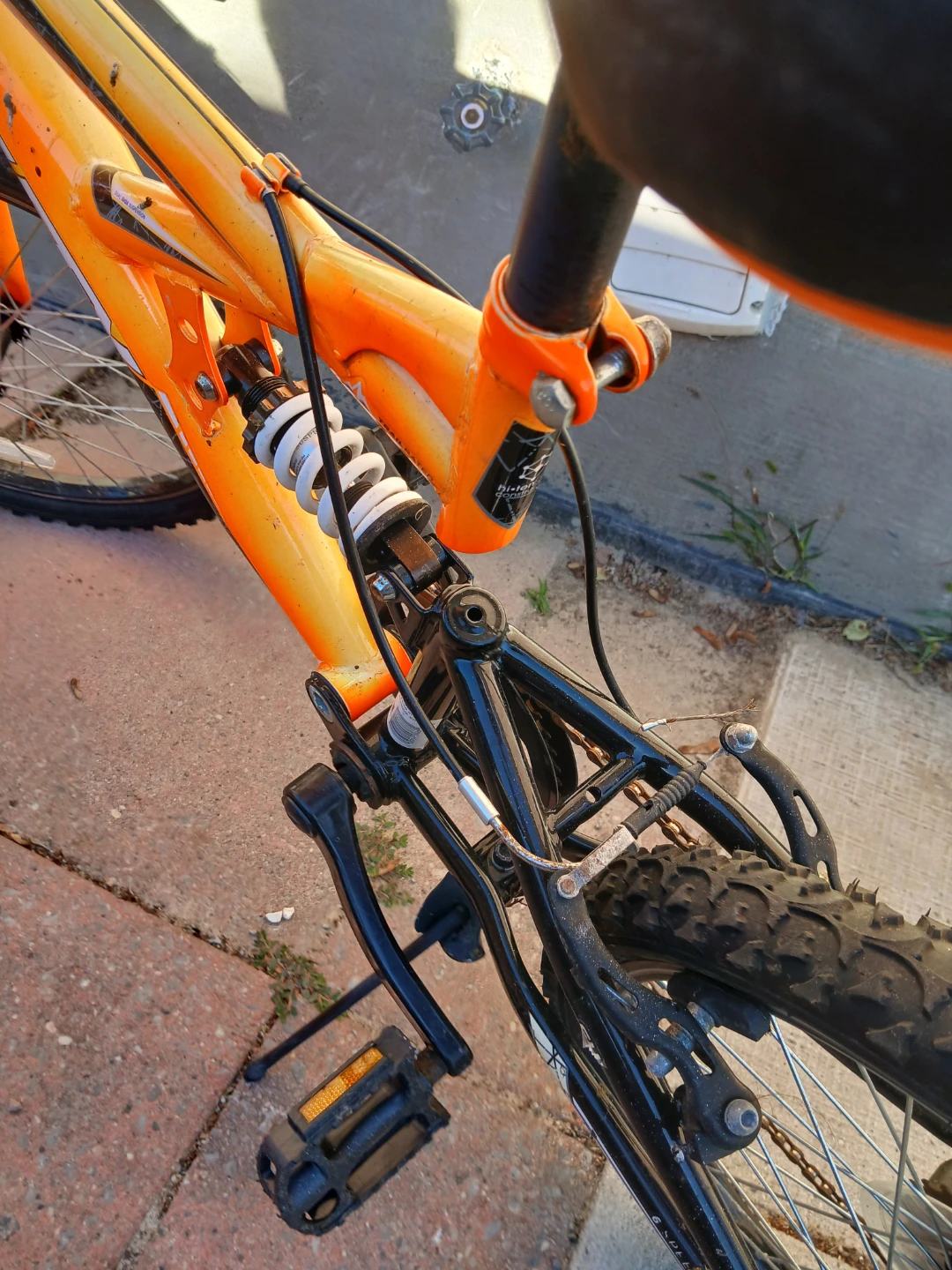 Orange mountain bike with dual suspension