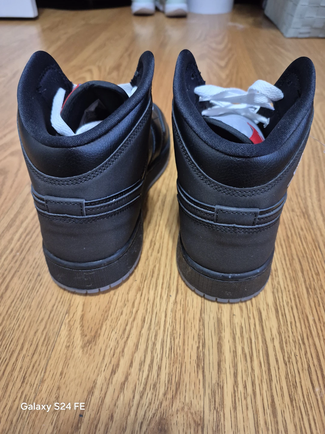 These are authentic Air Jordan 1 Mid sneakers in a black and red - photo 4