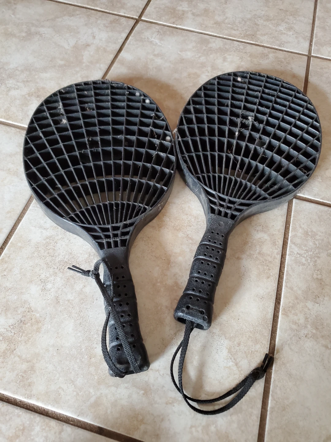 Two Black Plastic Beach Paddles