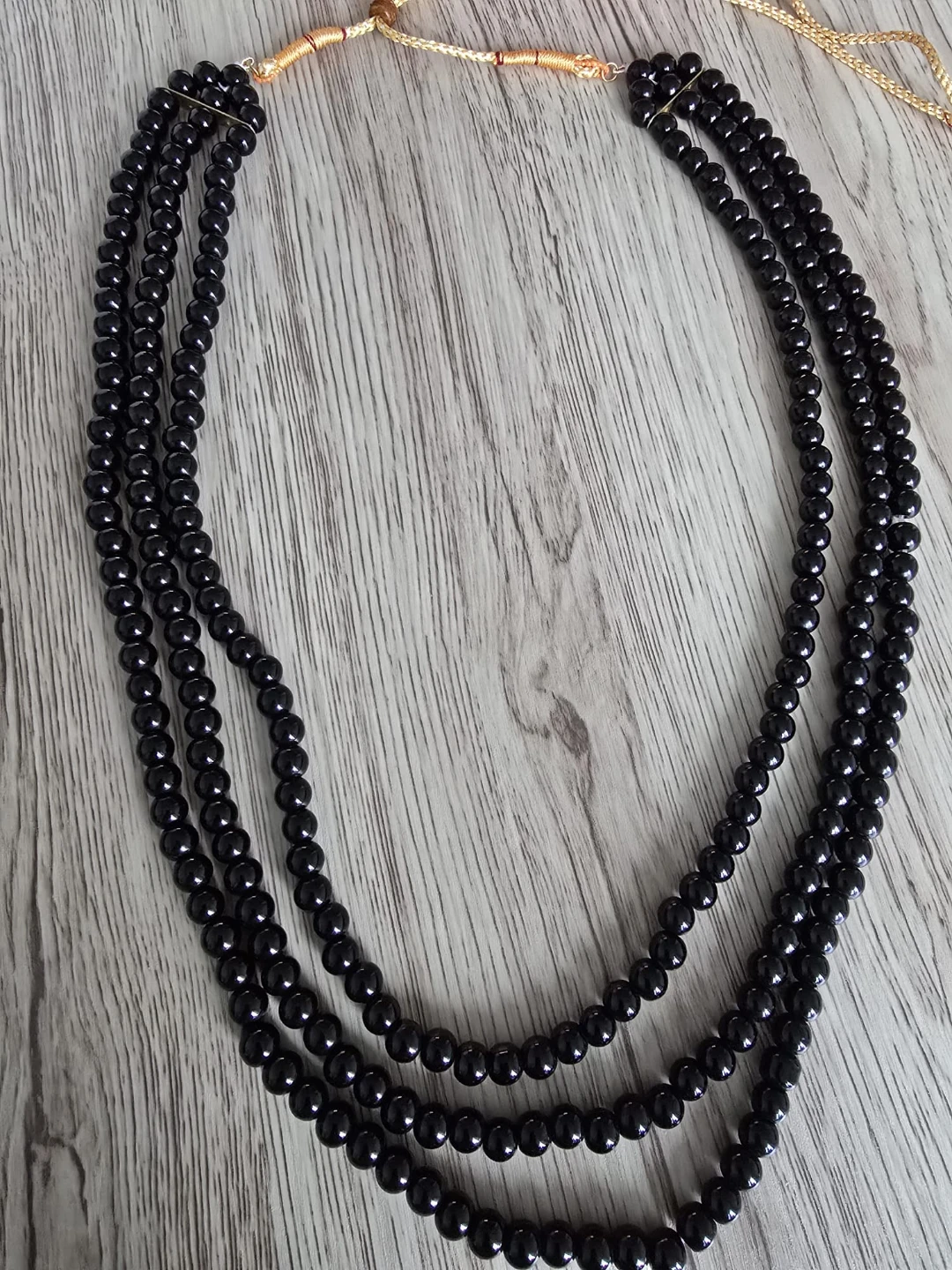 Three-strand black bead necklace