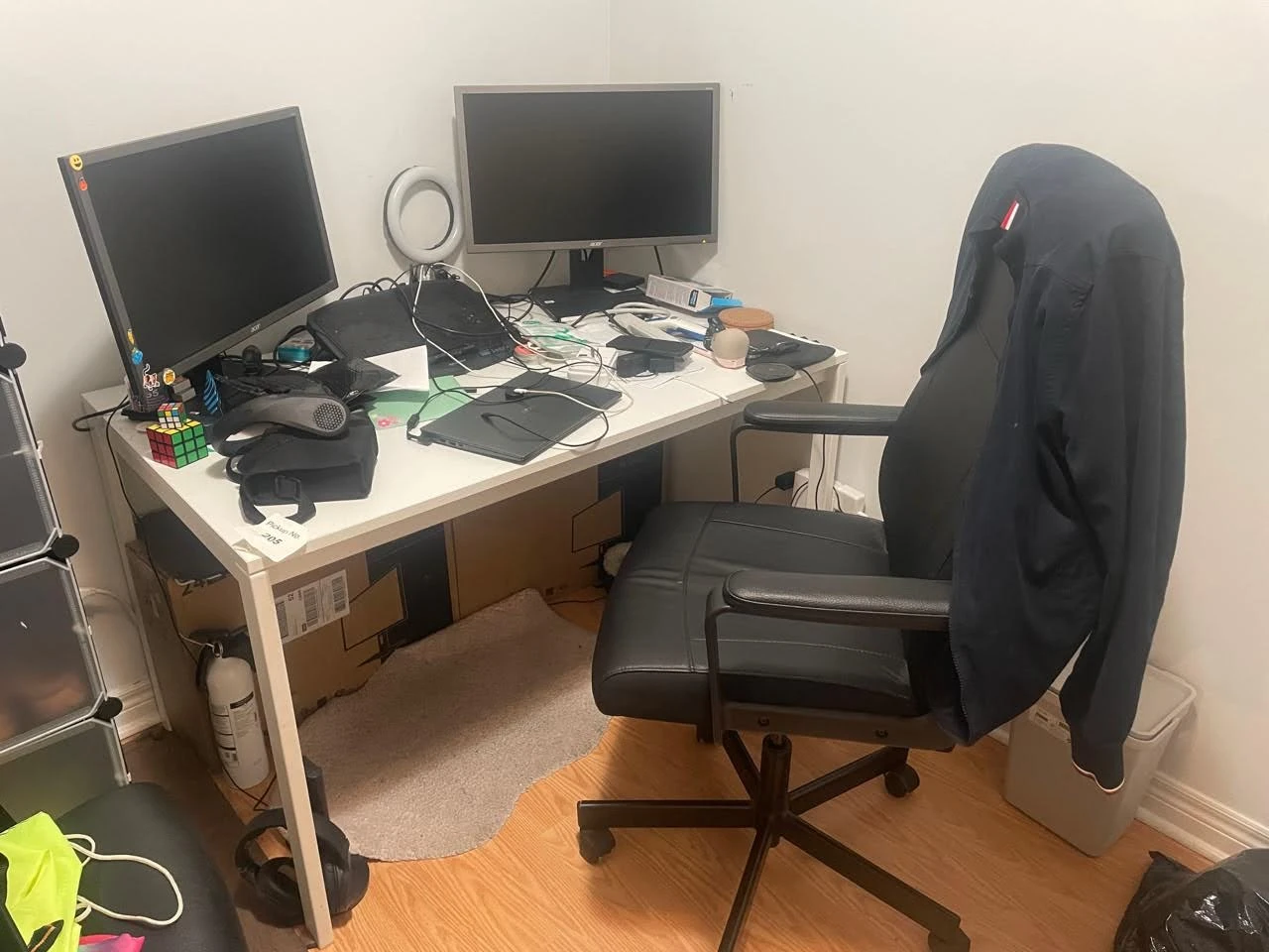 White desk with black office chair and monitors