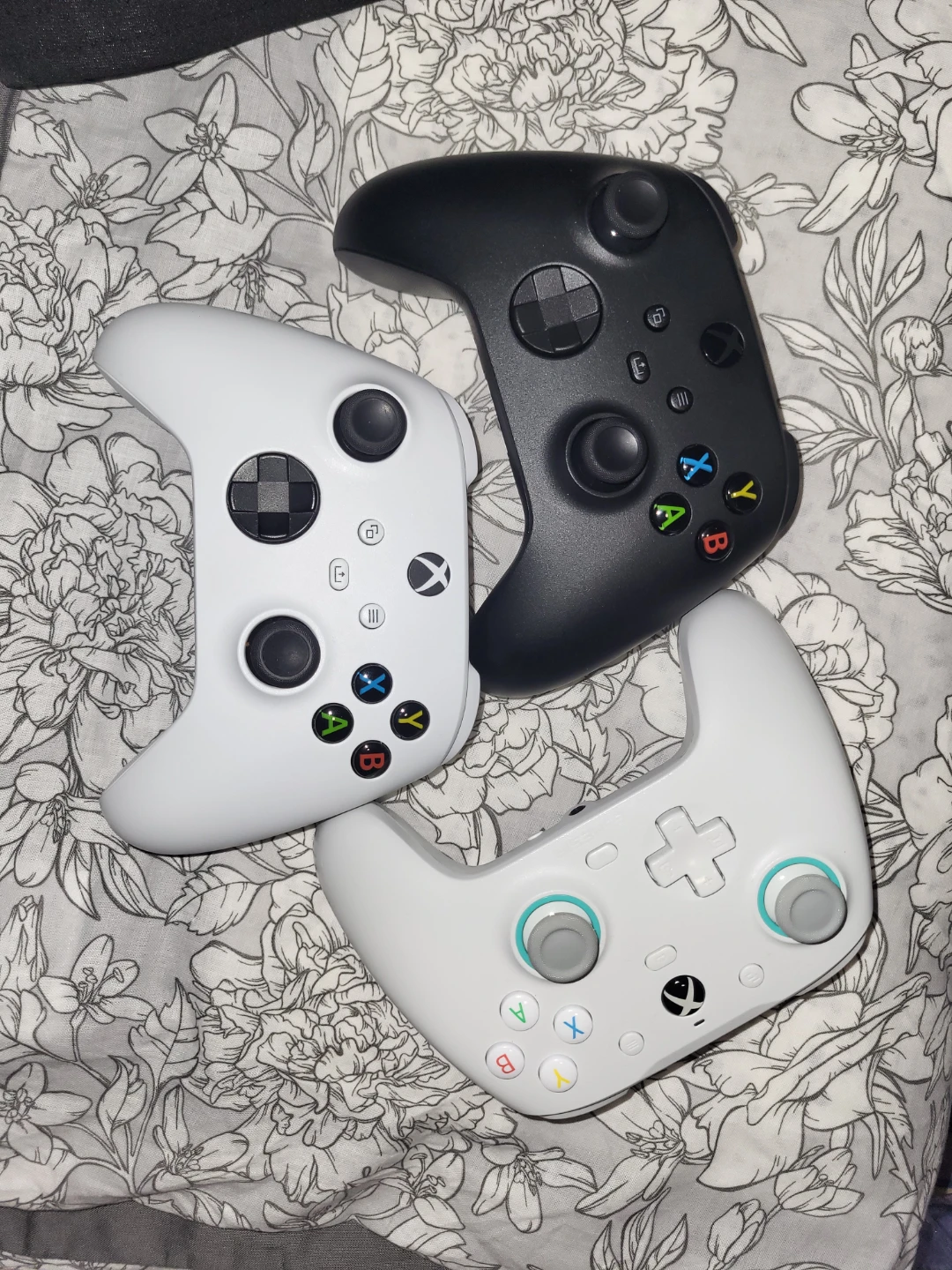 Three Xbox-compatible controllers