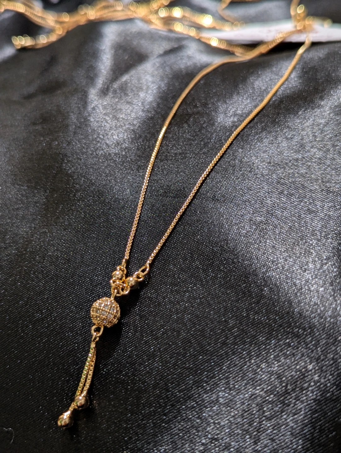Gold-toned lariat necklace with rhinestone bead