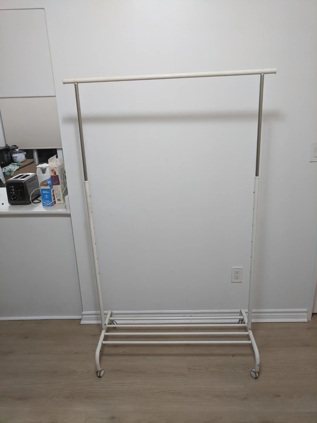 White metal clothing rack with wheels