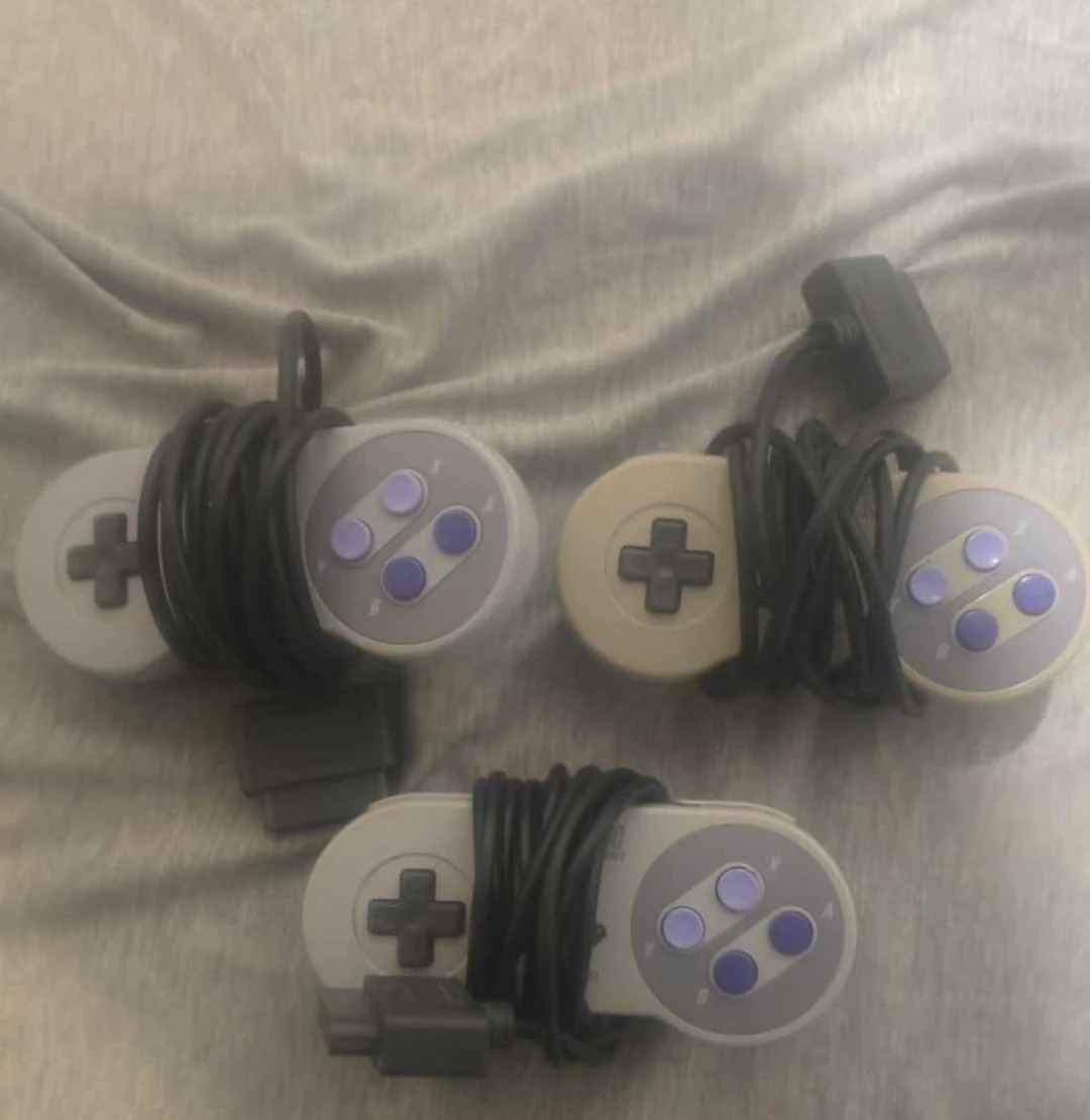 Three Super Nintendo Entertainment System Controllers