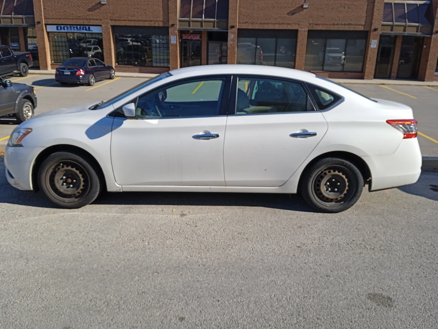 White Nissan Sentra sedan (contact)