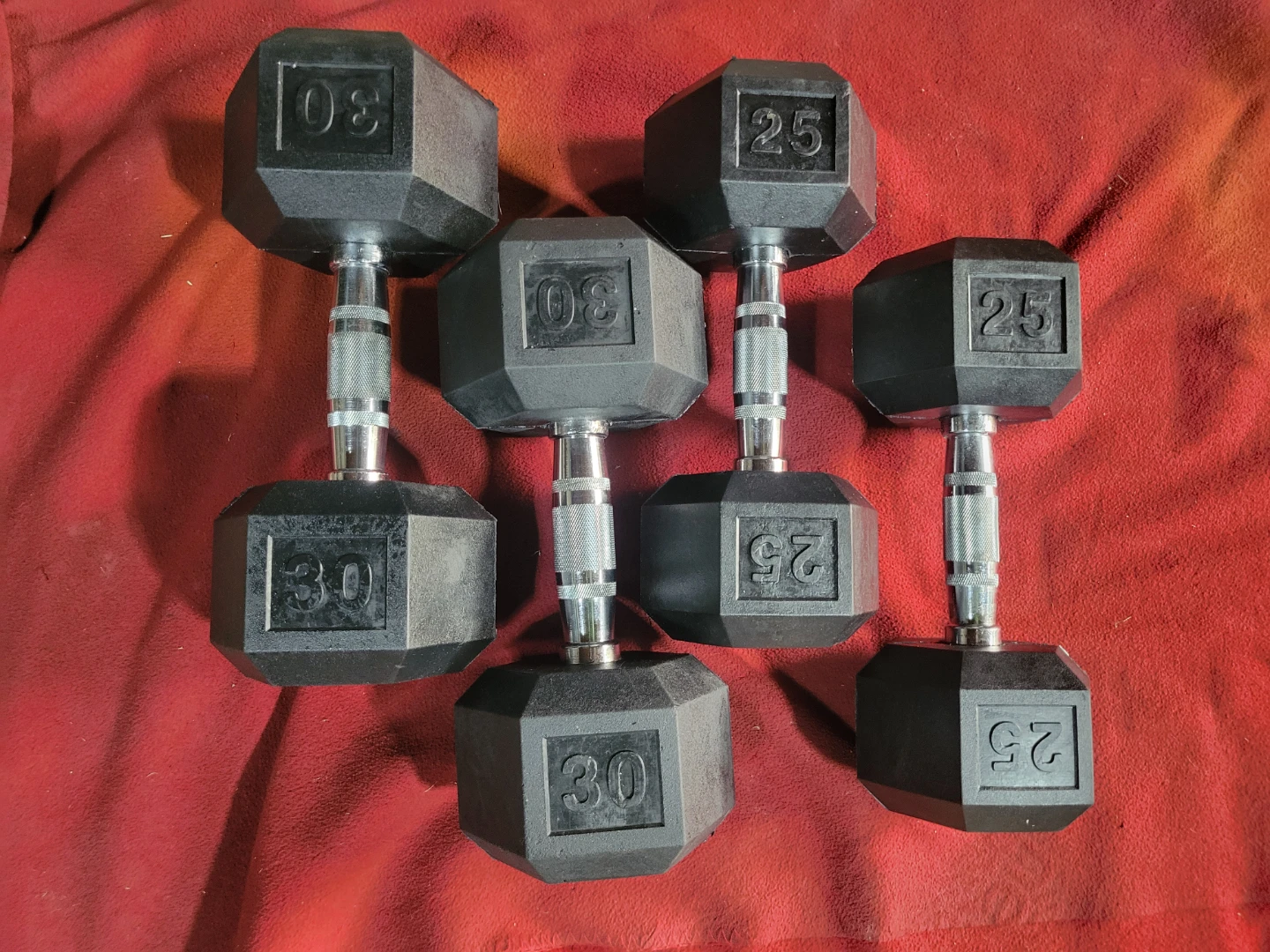SETS OF 30s AND 25s.  RUBBER COATED HEXHEAD DUMBBELLS