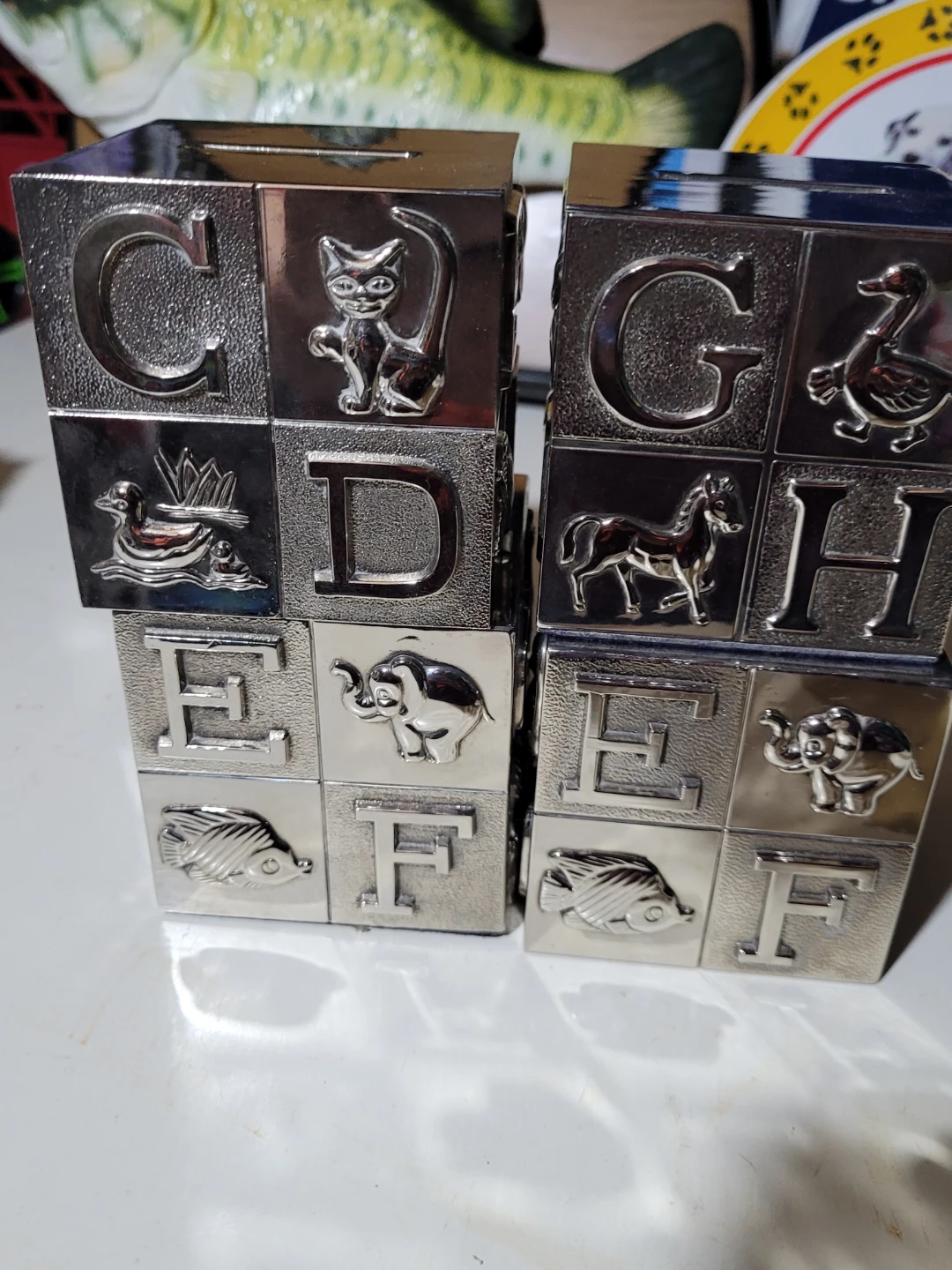 Two Silver-Tone Alphabet Blocks