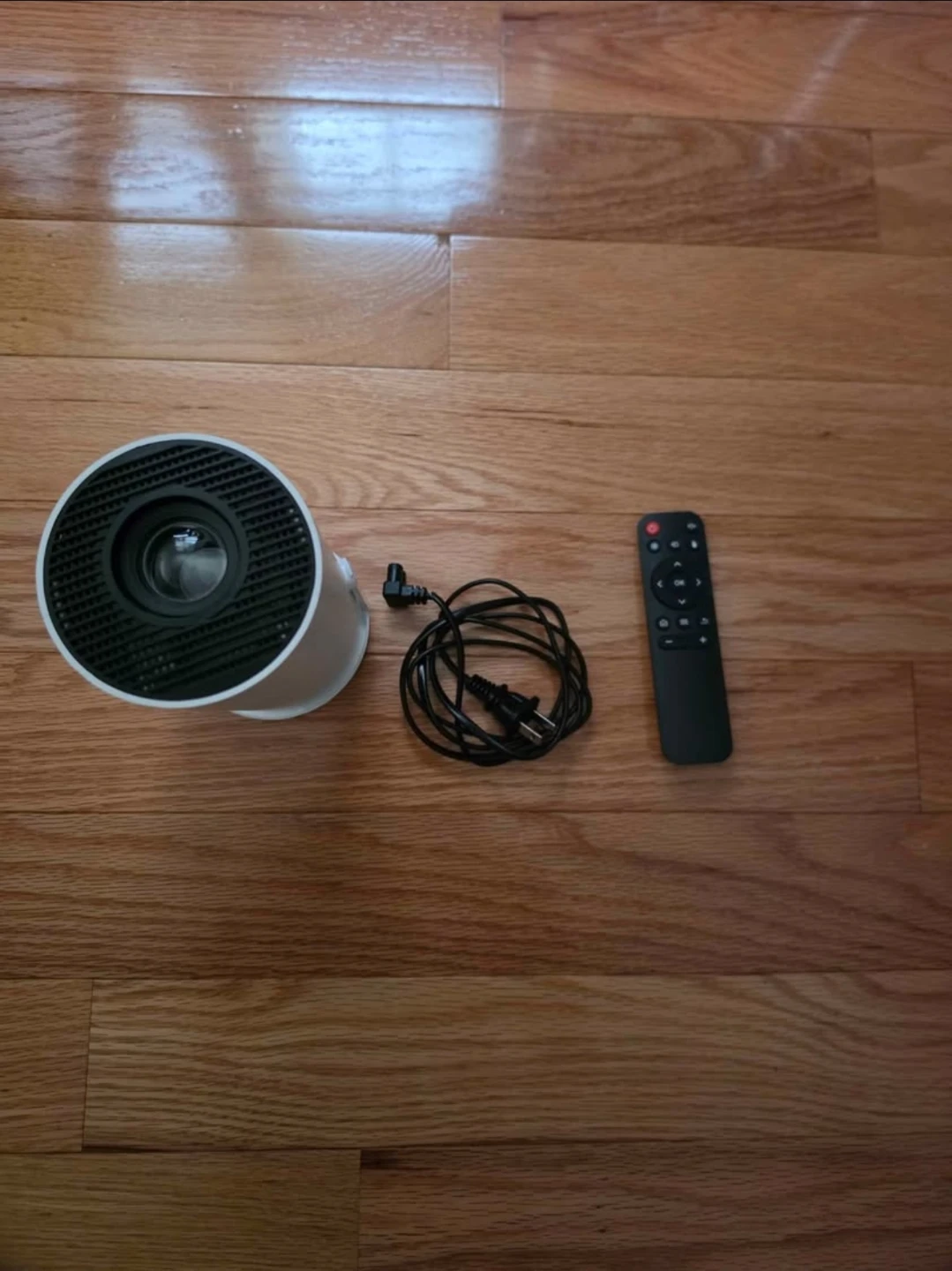 White Mini Projector with Remote TV app installed