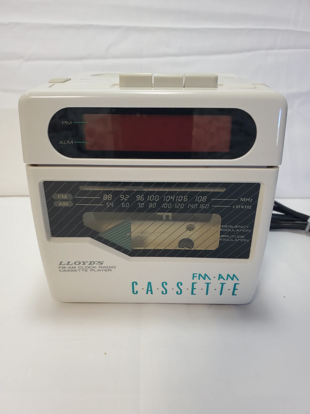Vintage Lloyd's AM/FM clock radio with a built-in cassette...