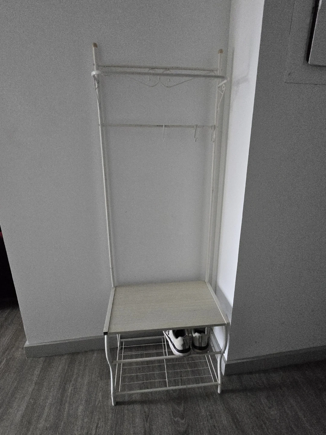 White metal coat rack with shoe storage shelf