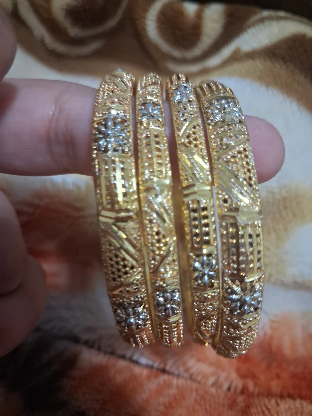 Set of four gold-tone metal bangles