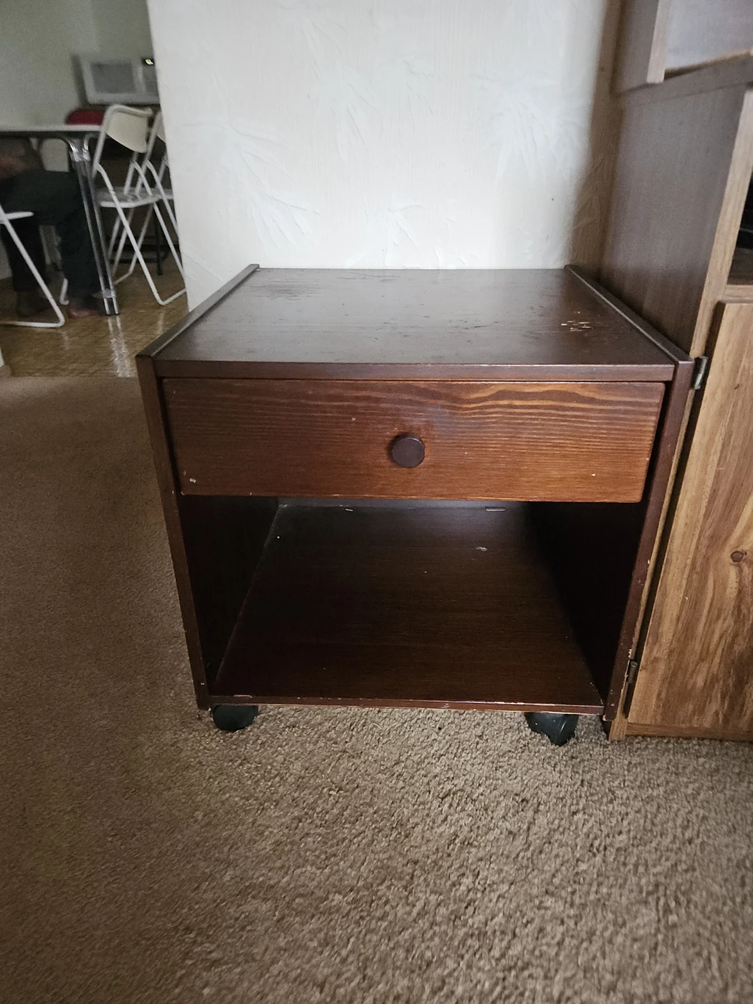 Dark brown wooden nightstand with drawer