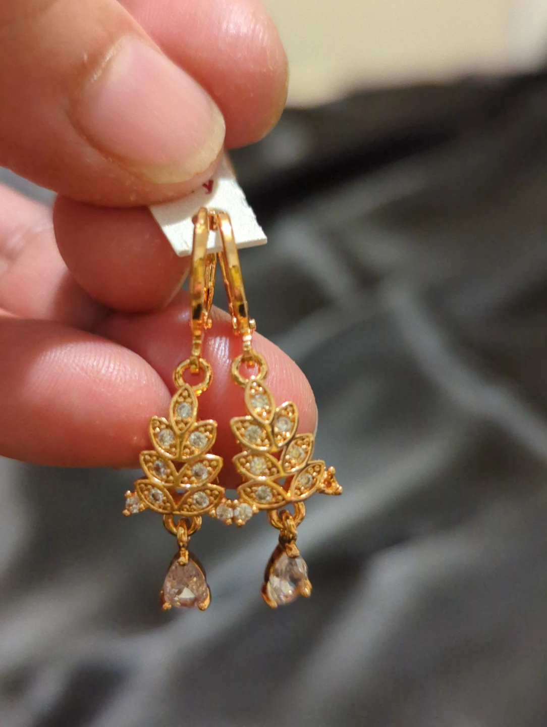Gold-tone leaf dangle earrings with drop stones